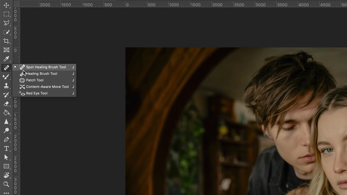 Patch tool selected, circle drawn around a blemish