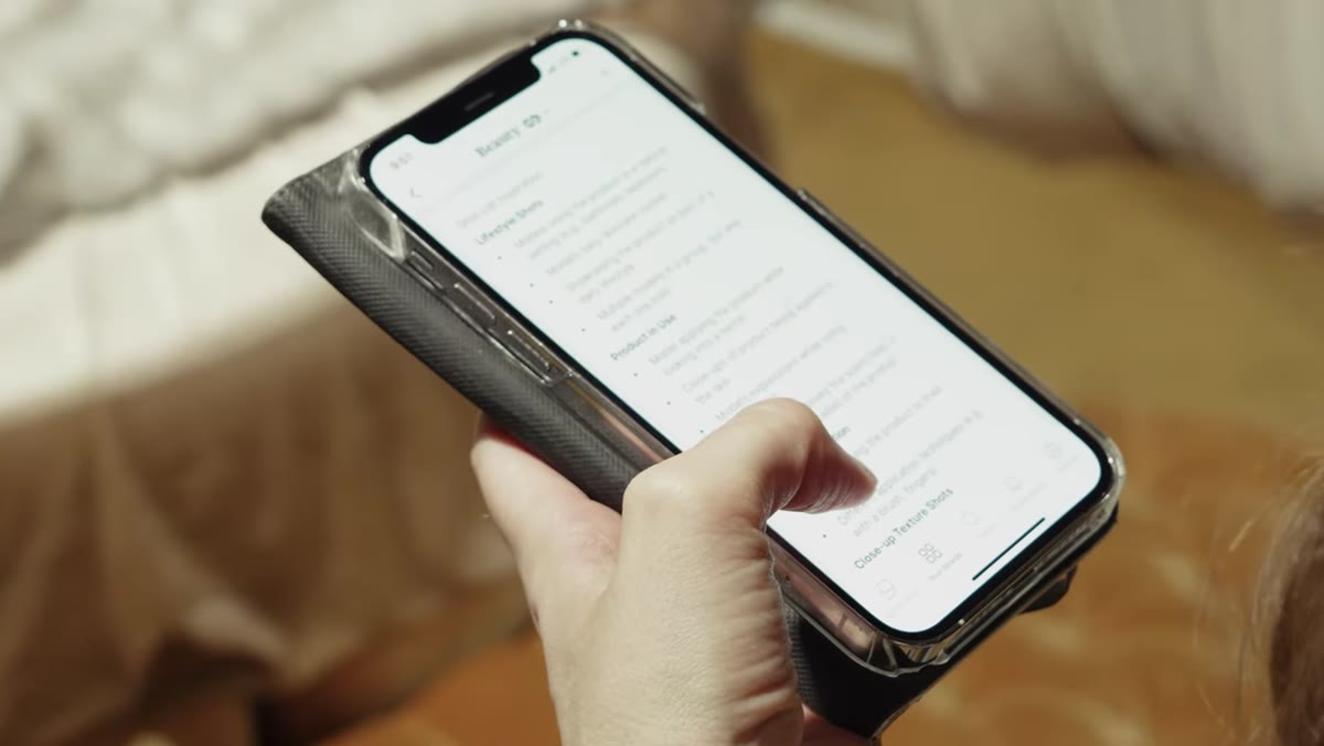 Rachel referencing the beauty brief on her phone during the shoot