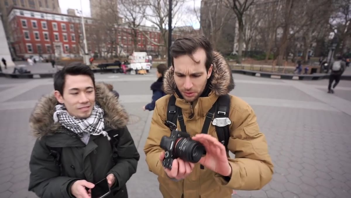 Pierre holding camera with 50mm lens attached